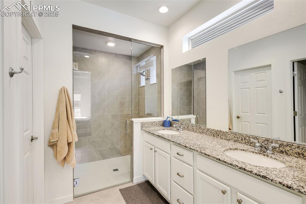 Image 20 of 36: Primary Bath with double vanity area and walk in shower