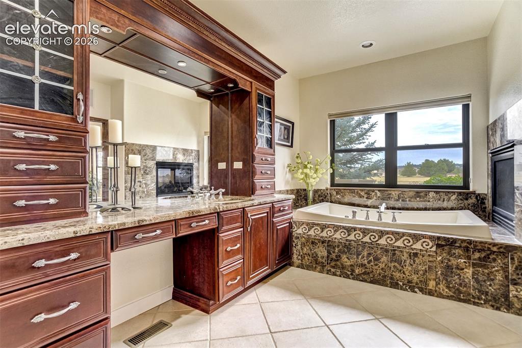 Image 16 of 46: jacuzzi tub & double sided fireplace
