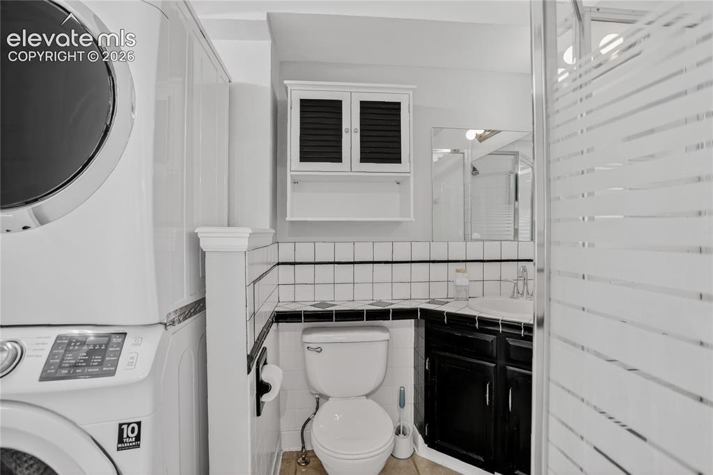 Image 12 of 20: Guest bath & laundry - lower level