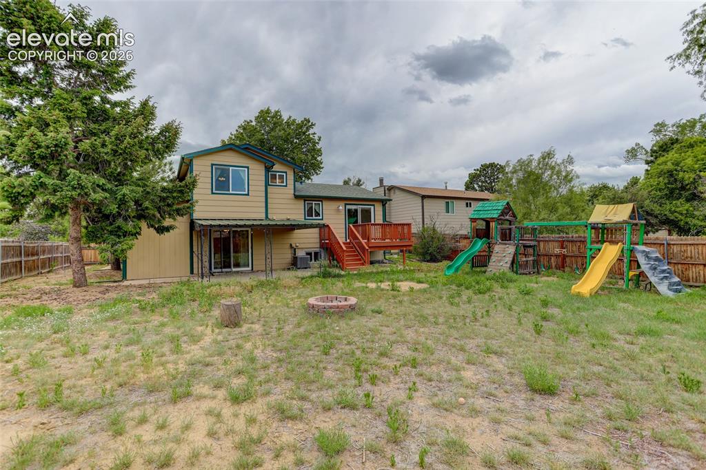 Image 20 of 20: Fully fenced backyard with firepit