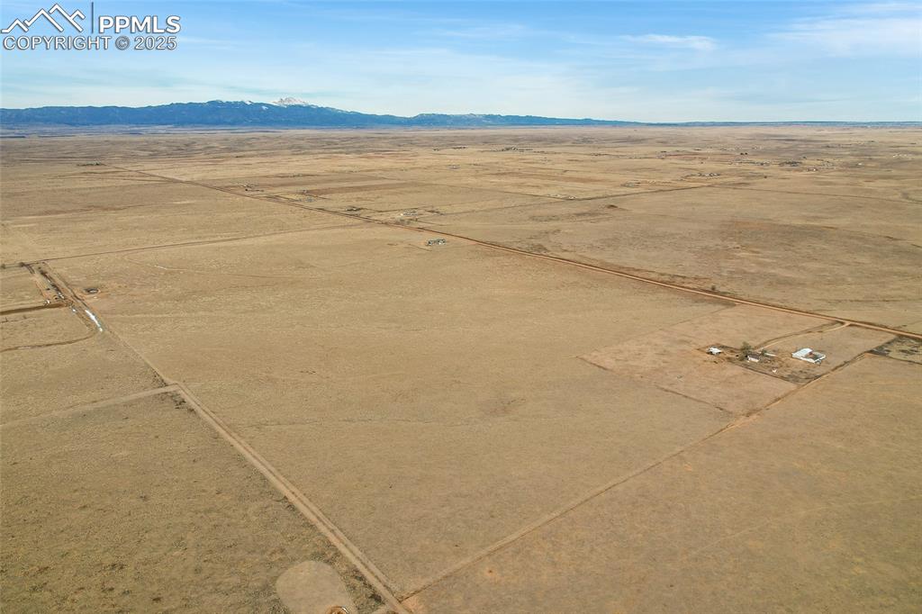 Image 4 of 8: Overview of rural landscape with a desert landscape and a mountainous backg