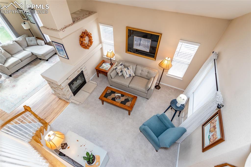 Image 14 of 47: Living area with plenty of natural light and a glass covered fireplace