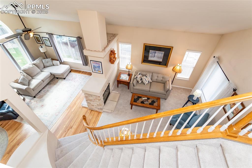 Image 15 of 47: Living area featuring light wood finished floors and stairway
