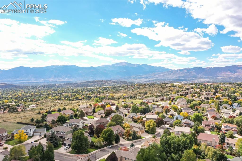 Image 2 of 47: Aerial perspective of suburban area featuring a mountain backdrop