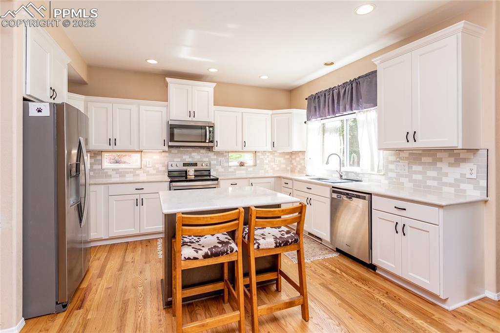 Image 20 of 47: Kitchen featuring white cabinets, appliances with stainless steel finishes,