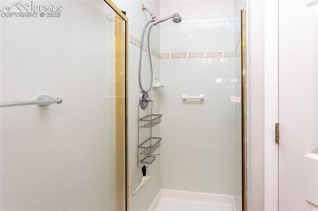 Image 24 of 47: Bathroom featuring a stall shower