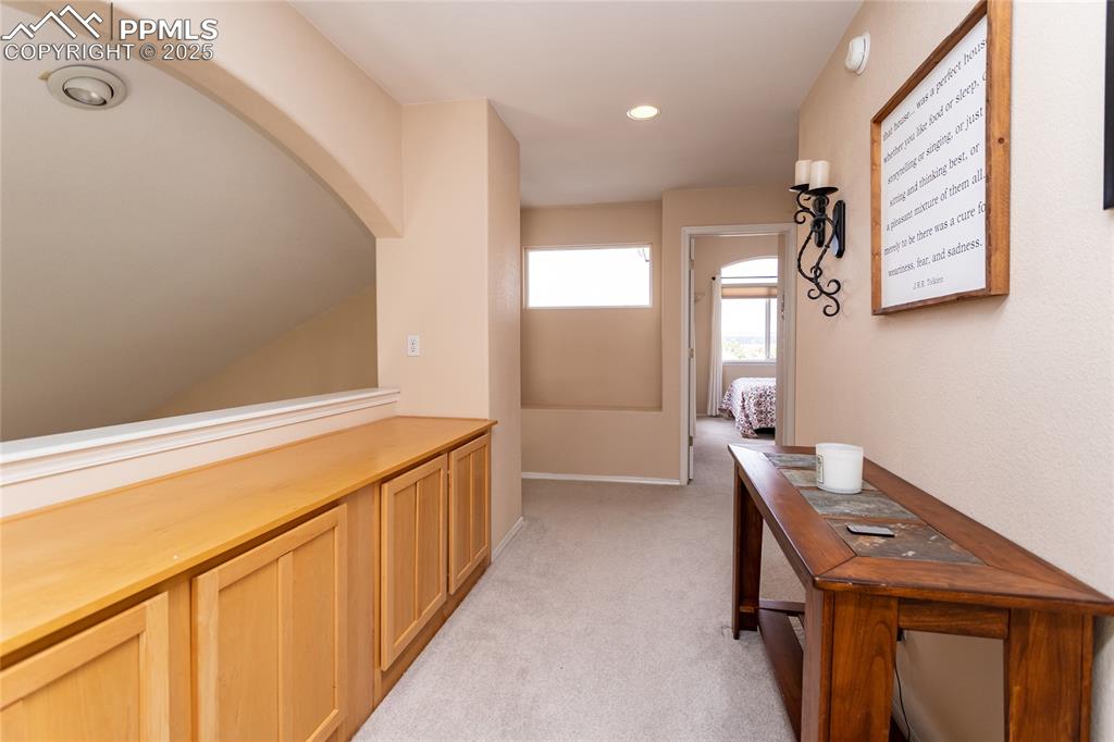 Image 27 of 47: Hallway featuring light colored carpet and recessed lighting