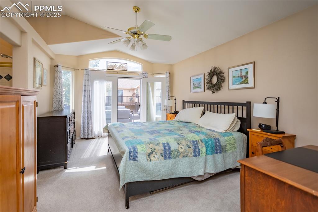 Image 30 of 47: Bedroom with lofted ceiling, light carpet, access to exterior, and ceiling