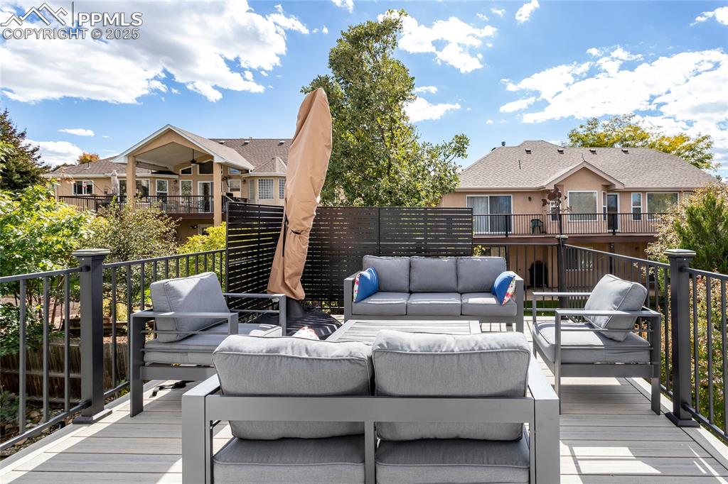 Image 34 of 47: Deck featuring an outdoor living space and grilling area