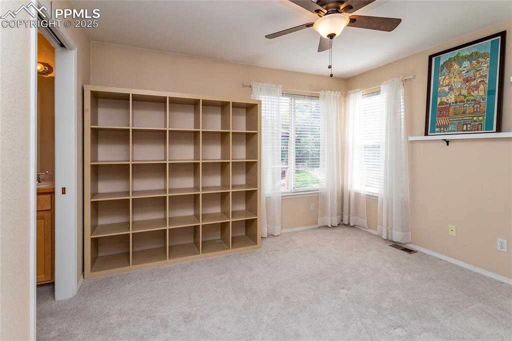 Image 37 of 47: Unfurnished bedroom featuring light carpet and ceiling fan