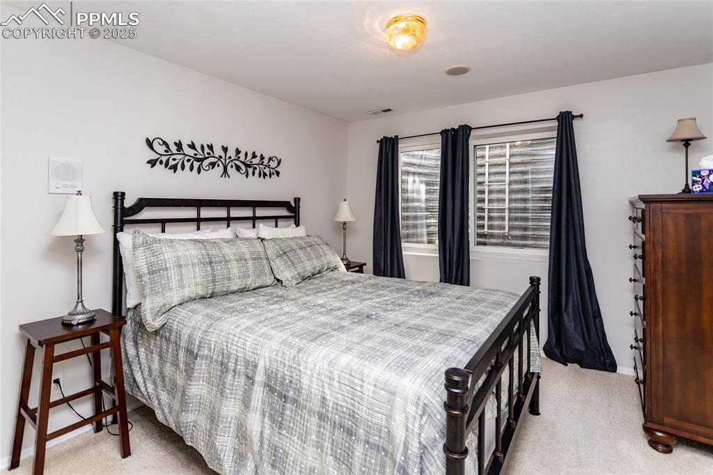Image 40 of 47: Bedroom with light carpet
