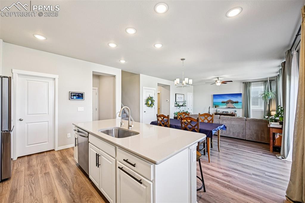 Image 20 of 50: Kitchen with stainless appliances, large island with breakfast bar, quartz 