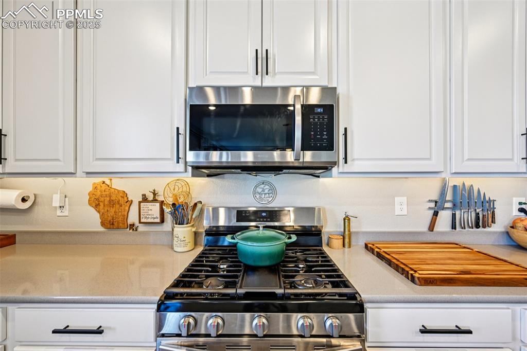 Image 22 of 50: Kitchen highlighting the gas stove and ample countertop space