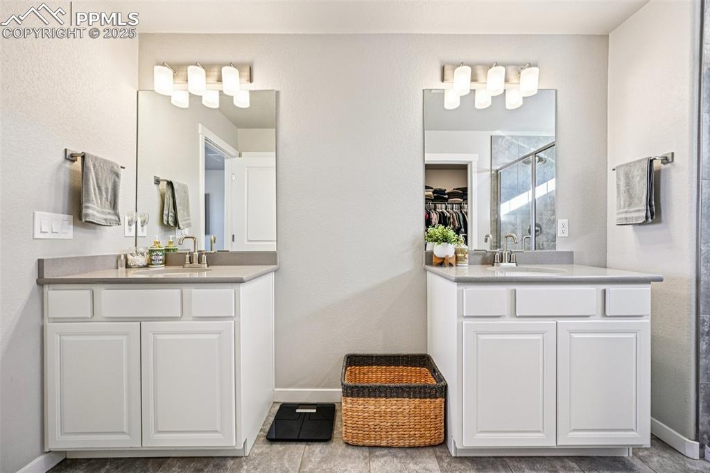 Image 29 of 50: Primary bathroom highlighting the dual sinks