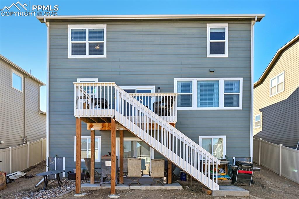 Image 45 of 50: Back of home highlighting the back deck and walk out basement