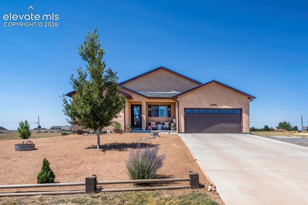 Image 1 of 40: Stucco exterior with an attached two-car garage