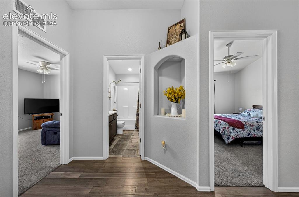 Image 26 of 40: Hallway featuring wood-finish flooring, a decorative wall niche, and an arc