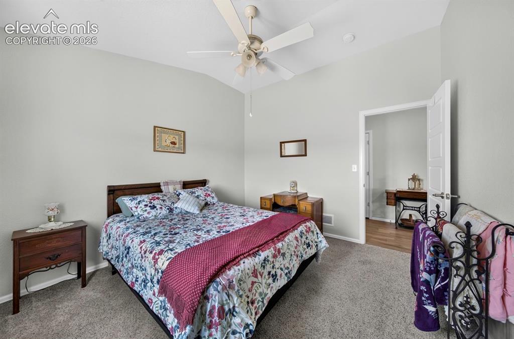 Image 28 of 40: Vaulted ceiling with neutral wall tones and textured carpeting