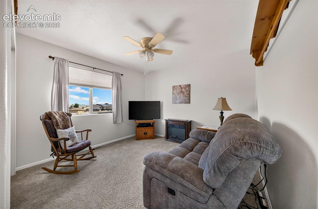 Image 32 of 40: BR #4 a window with cellular shades, a ceiling fan