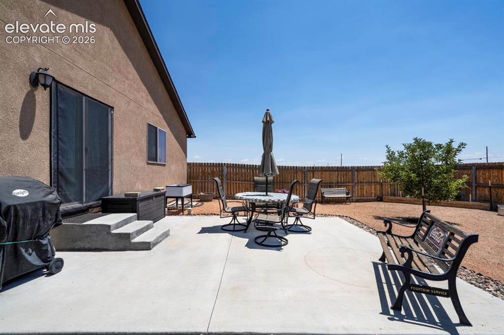 Image 38 of 40: Expansive concrete patio offering direct access to the interior via a slidi