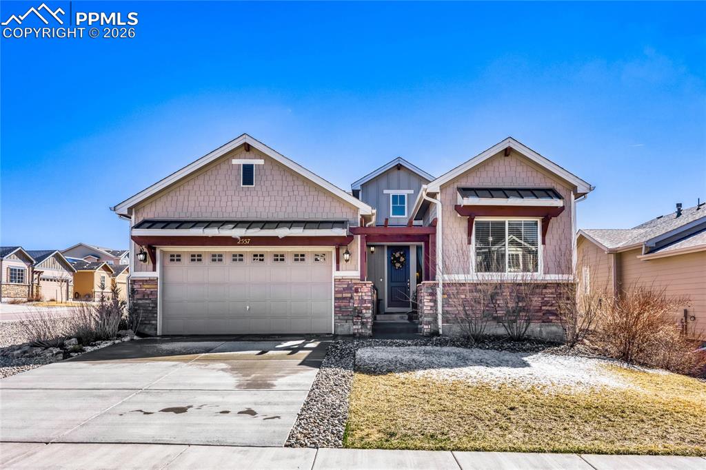 Image 1 of 30: Craftsman inspired home with a two car garage, and stone siding