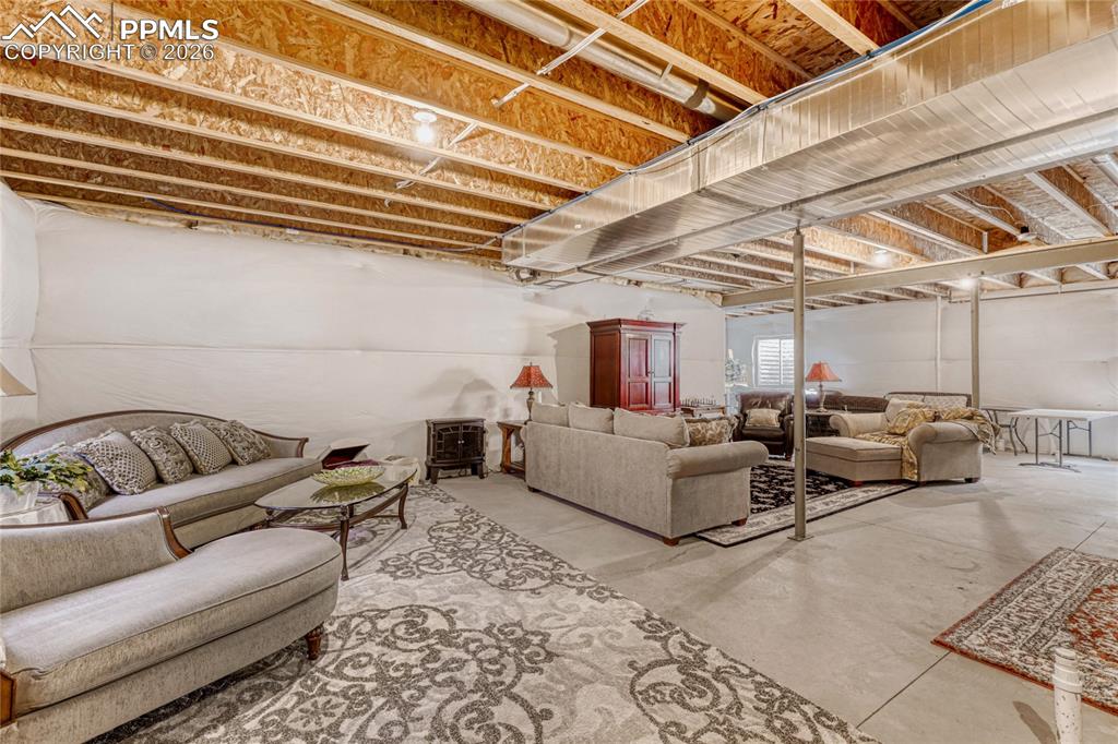 Image 16 of 30: Living area featuring concrete floors