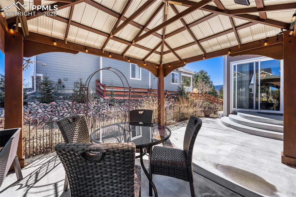 Image 28 of 30: Wooden deck with a patio area, outdoor dining area, and a gazebo