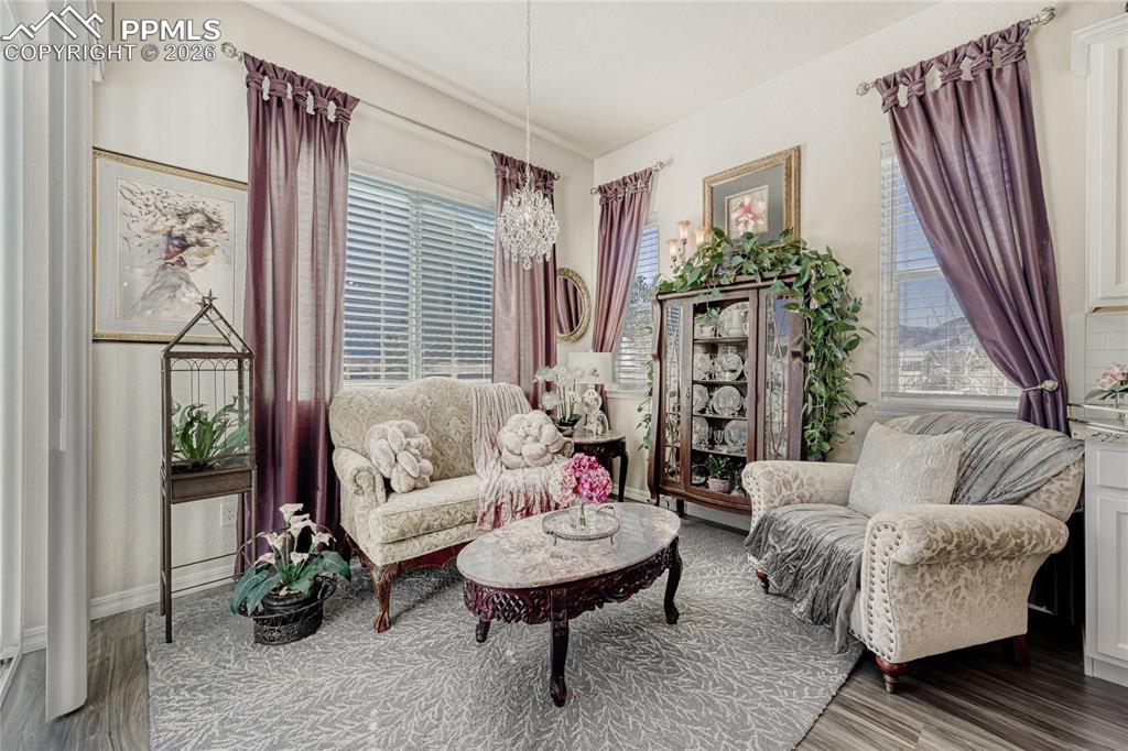 Image 6 of 30: Dining area currently used as a Sitting room featuring suspended lighting. 