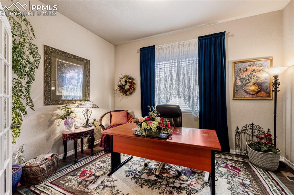 Image 7 of 30: Home office featuring LVP floors, glass french doors. 