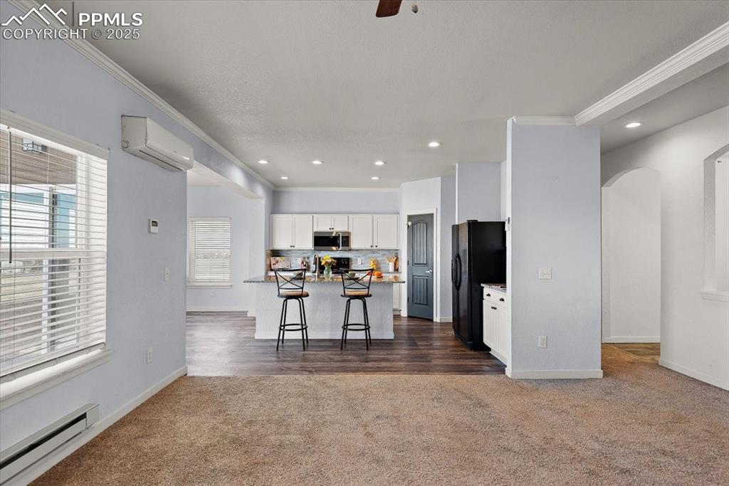 Image 12 of 33: Kitchen featuring stainless steel microwave, a kitchen breakfast bar, a kit