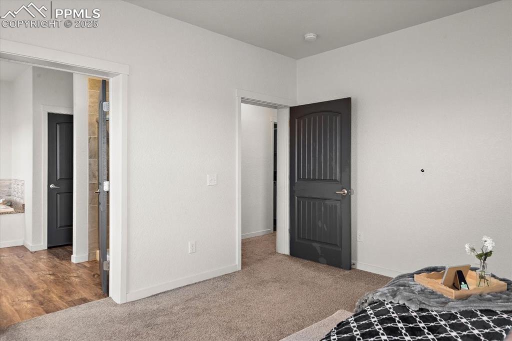 Image 23 of 33: Carpeted bedroom featuring baseboards