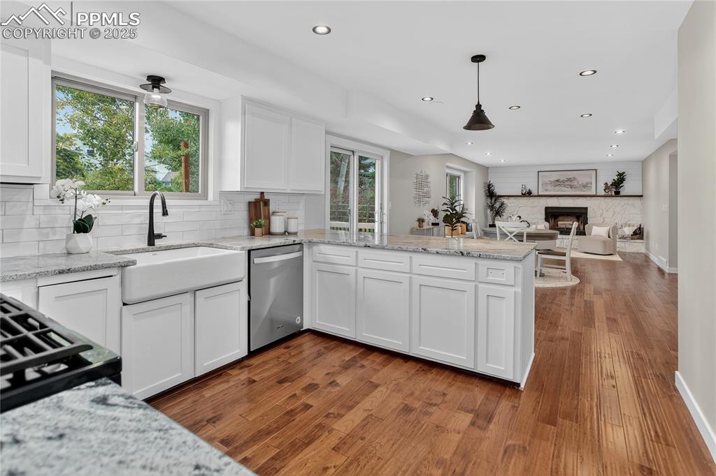 Image 8 of 32: Stone counters & farm-style sink