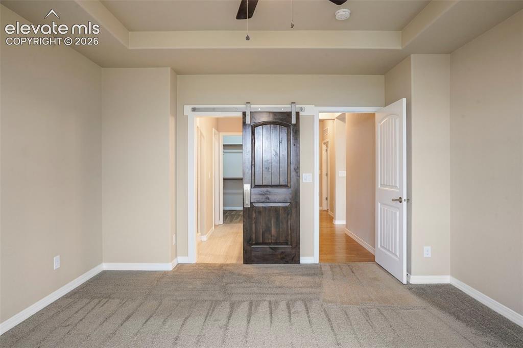 Image 14 of 48: Modern-style barn door into Master Bath