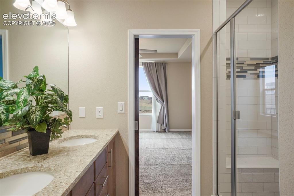 Image 16 of 48: Oversized shower with bench seat and upgraded shower tile