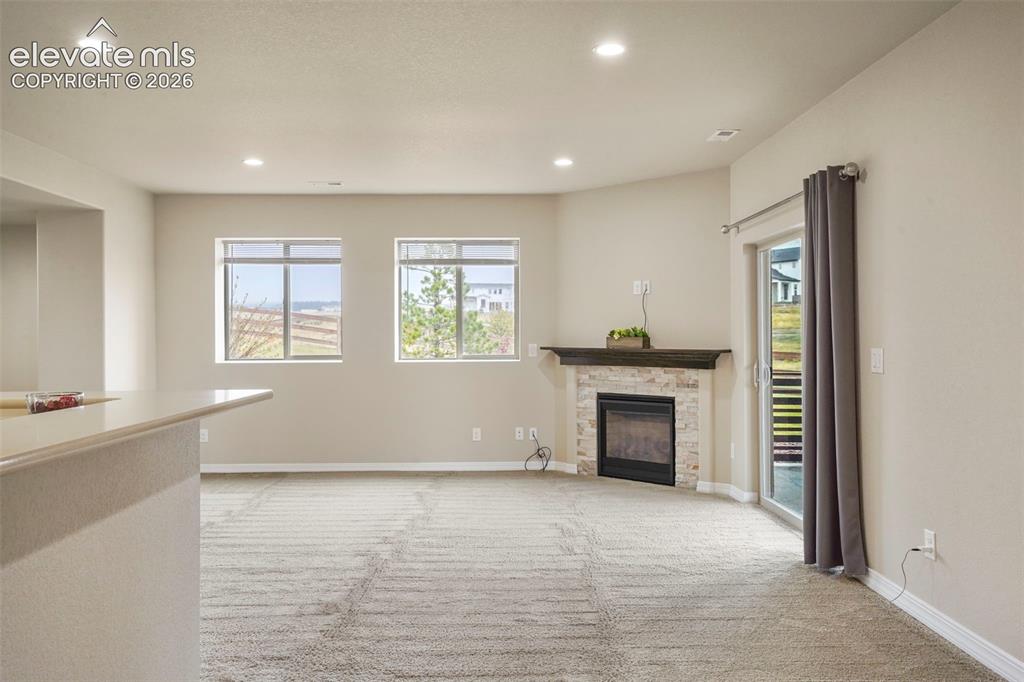 Image 21 of 48: Open and bright Family room with fireplace and garden level windows