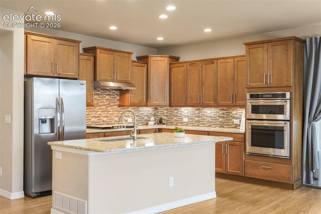 Image 3 of 48: Upgraded Kitchen with quartz countertops, maple cabinetry, gas cooktop and 