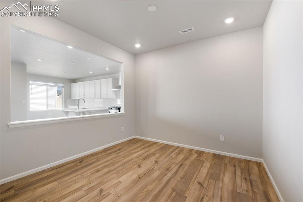 Image 10 of 33: Unfurnished living room with light wood-style flooring and recessed lightin