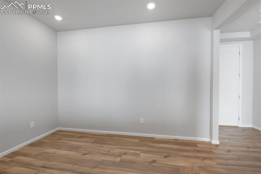 Image 12 of 33: Empty room featuring light wood finished floors and recessed lighting