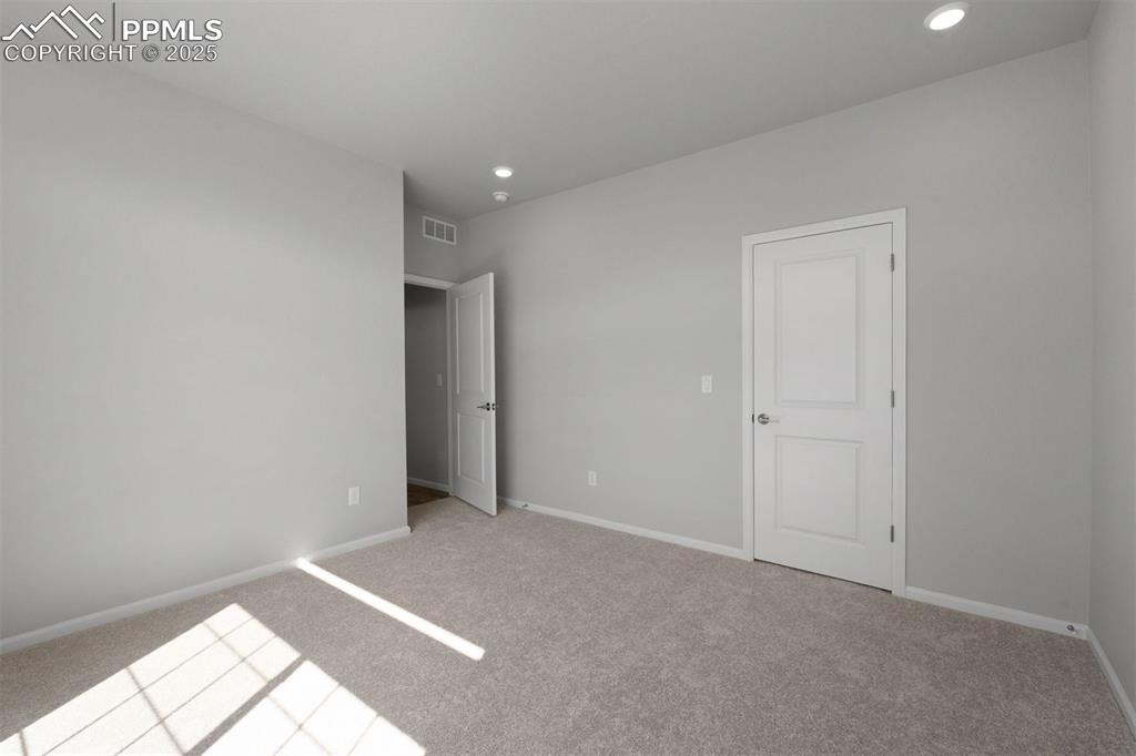 Image 31 of 33: Unfurnished bedroom featuring light carpet and recessed lighting