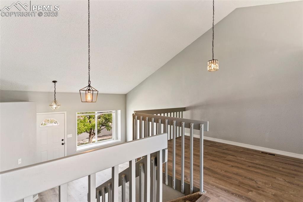 Image 8 of 35: Stairway with wood finished floors and baseboards