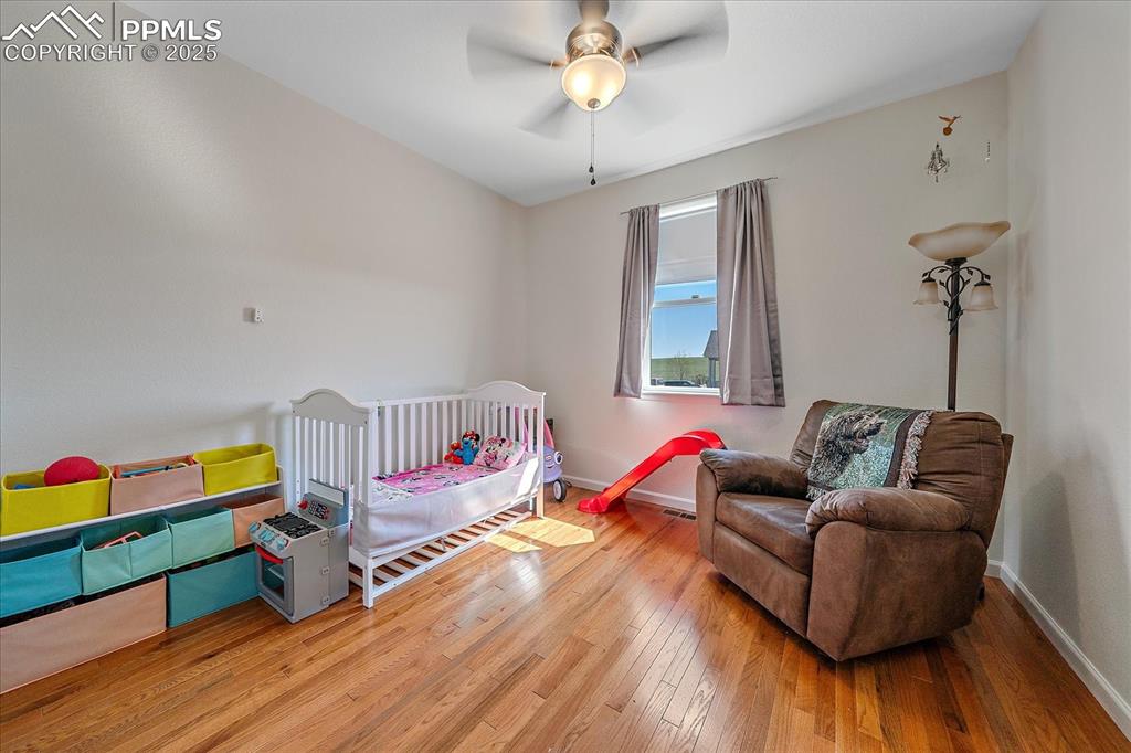 Image 20 of 35: Bedroom with hardwood / wood-style flooring, baseboards, and ceiling fan