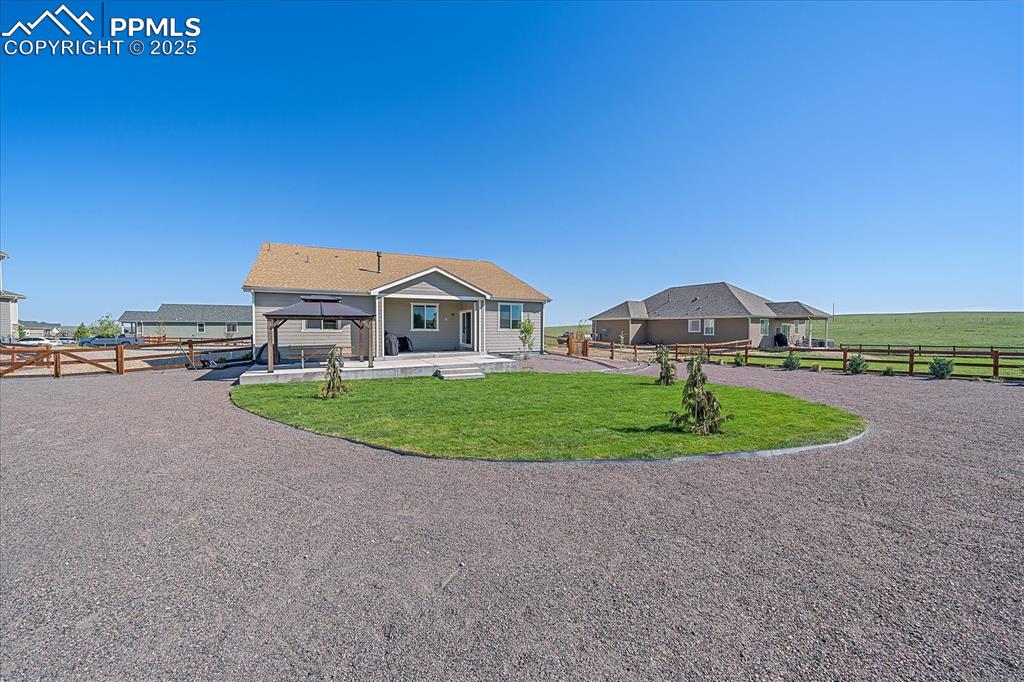 Image 25 of 35: Rear view of house with a gazebo