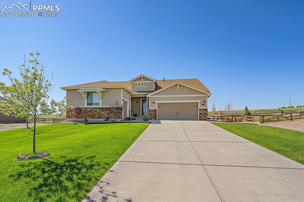 Image 3 of 35: Craftsman inspired home featuring stone siding, an attached garage, concret