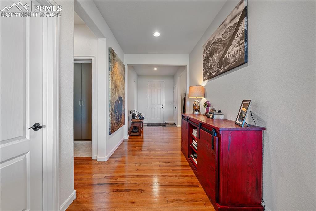 Image 4 of 35: Hall with light wood-style flooring, recessed lighting, and baseboards