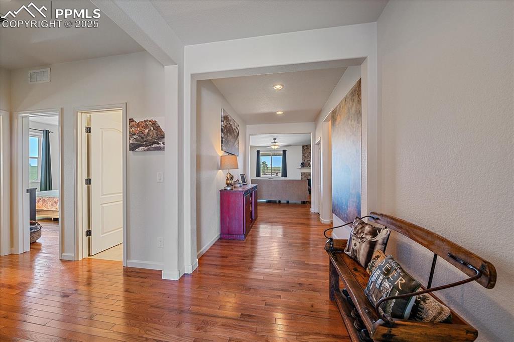 Image 5 of 35: Hall featuring hardwood / wood-style flooring, baseboards, and recessed lig