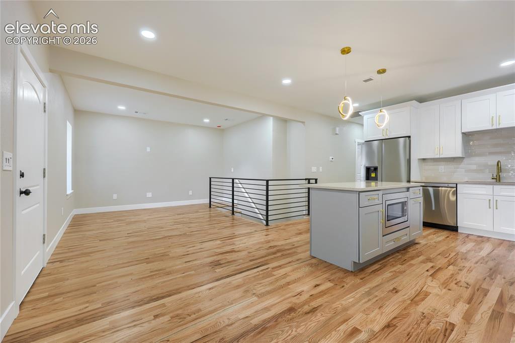 Image 11 of 49: Another perspective of the living room, dining area and kitchen.