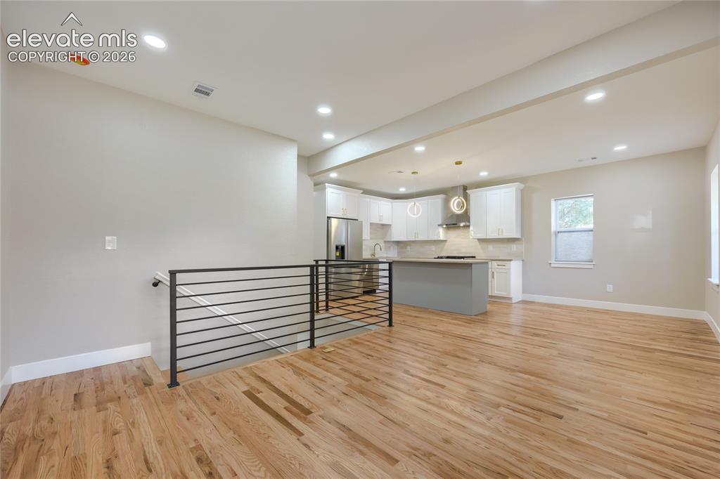 Image 5 of 49: A view of your new living room, dining area and kitchen.