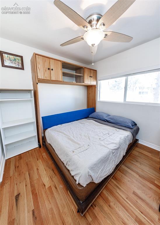 Image 23 of 47: Hardwood flooring, built-in cabinetry, ceiling fan with integrated lighting