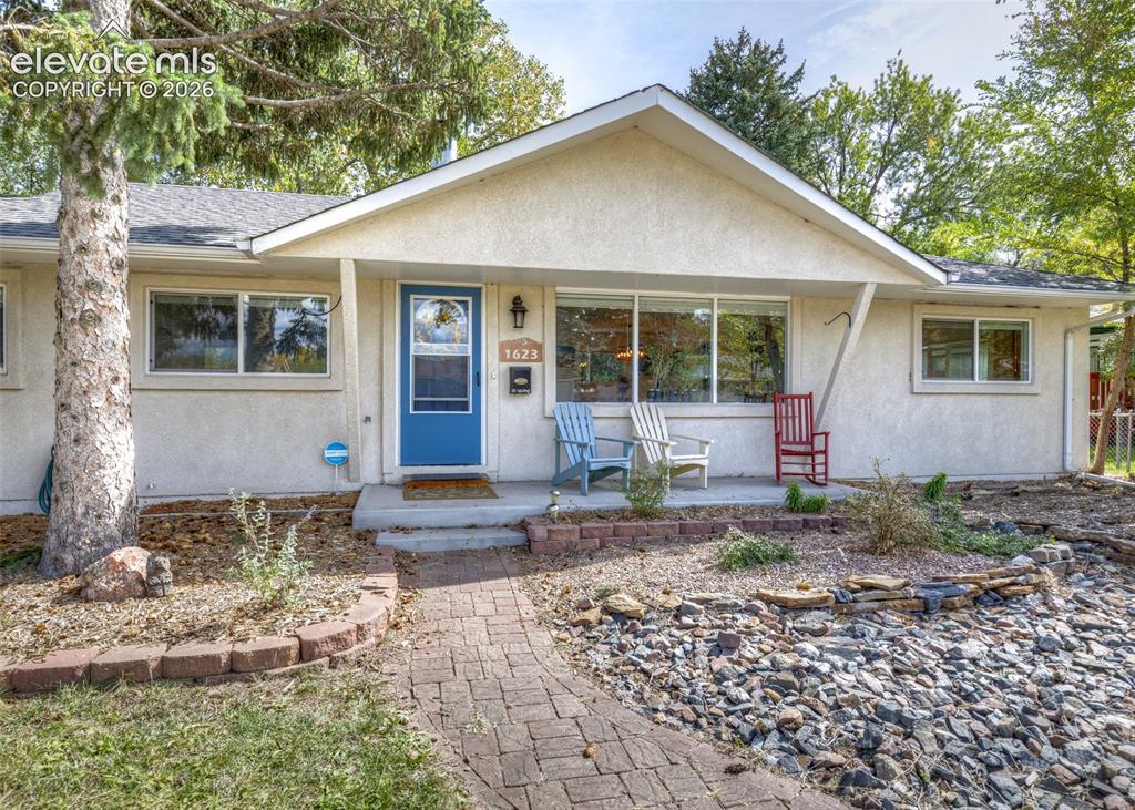 Image 3 of 47: Stucco exterior with a pitched roof, front entry porch, and brick paver pat