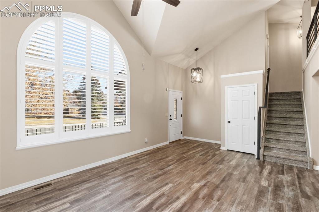 Image 12 of 49: The large arched window with plantation shutters allows an abundance of nat